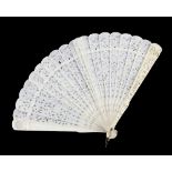 A Cantonese ivory fan with 20 sticks; each stick of typical reticulated form carved with designs