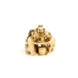 A small ivory okimono or netsuke carved as a Temple Nio and an Archer being served by an Oni or