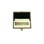 Set of four sterling silver and enamel bridge pencils, in fitted case, each 9 cm long, (4).