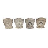 Set of four menu holders, each shield-shaped plaque with floral scrolls and a central cartouche