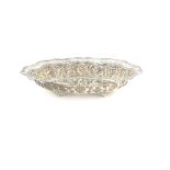 Indian silver dish with pierced decoration serpentine border, embossed with fruit, on four shaped