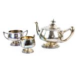 George V silver three piece tea service, comprising teapot, cream jug and sugar bowl, with floral