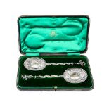 Edward VII pair of silver spoons with Bacchus terminals and repousse decorated bowls, Goldsmiths &