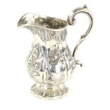 George III silver cream jug with embossed decoration on shaped foot, London, 1771, 6oz, 186g,.