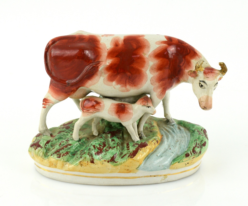 A pair of 19th century Staffordshire models of cows and calves, each 23 cm wide. - Image 6 of 8