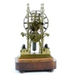 Victorian Gothic brass Skelton clock mounted with a pair of bronze lions on plinths, chain driven