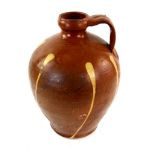Brown and cream glazed terracotta olive oil bottle vase with ring handle 34cm Provenance: Part of 35