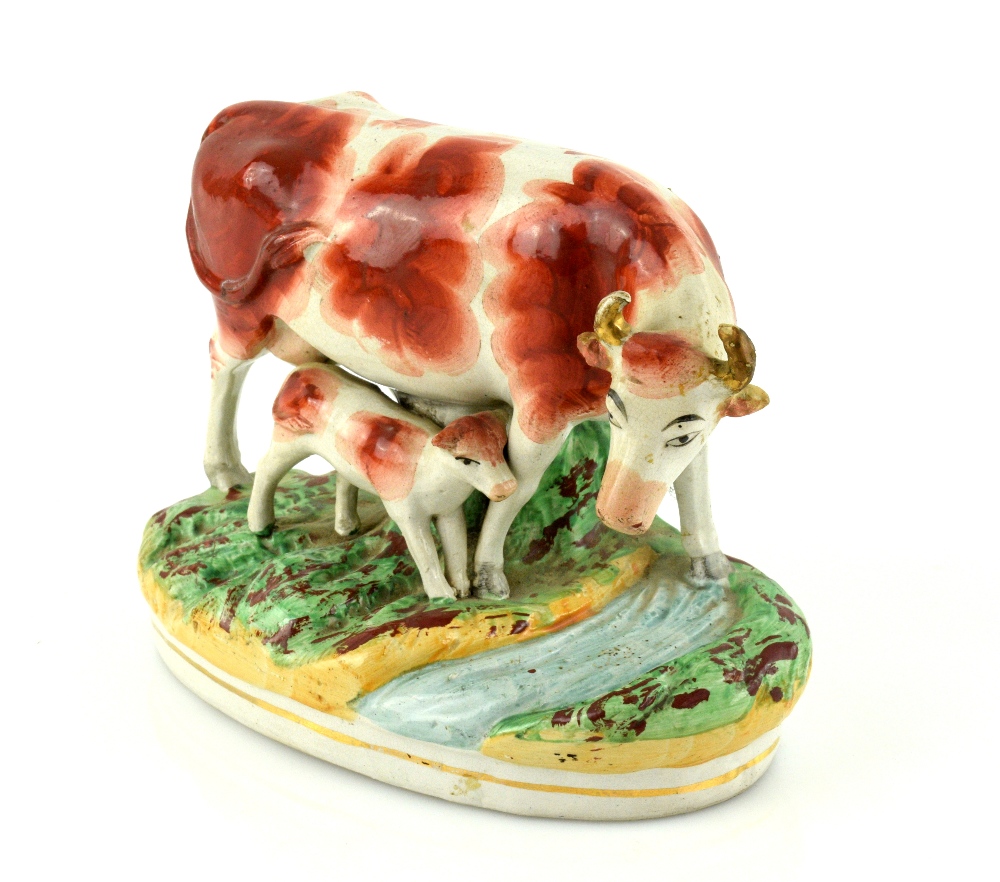 A pair of 19th century Staffordshire models of cows and calves, each 23 cm wide. - Image 7 of 8