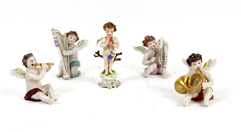 Continental porcelain figures of cherubs with musical instruments, one holding a flaming heart,