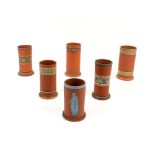 Early 20th century terracotta spill vase with a horizontal bands of decoration 12cm and five other