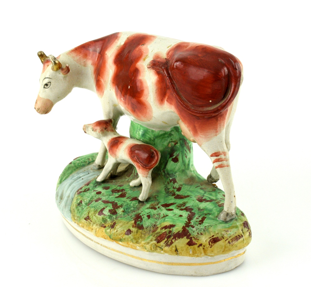 A pair of 19th century Staffordshire models of cows and calves, each 23 cm wide. - Image 3 of 8