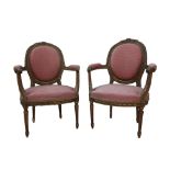 Pair of French carved and giltwood upholstered armchairs on turned and reeded supports.