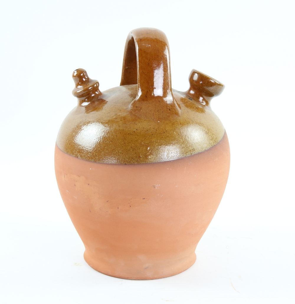 Brown part glazed terracotta oil bottle with ring handle 26cm Provenance: Part of 35 lot