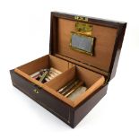 Modern mahogany brass bound humidor 35cm wide, and a small collection of cigars (unknown condition).