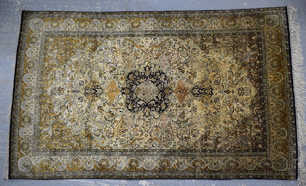 Persian blue ground silk rug , with a main blue border, the centre with repeating foliate forms