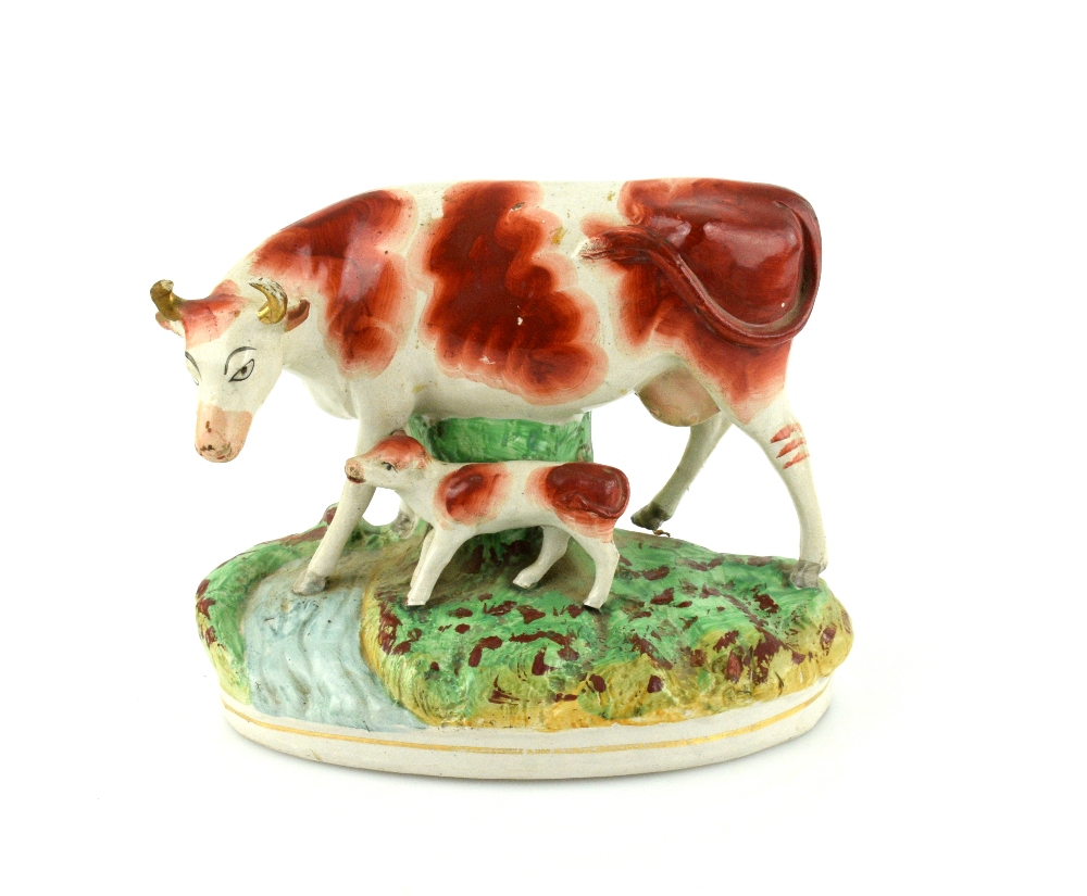 A pair of 19th century Staffordshire models of cows and calves, each 23 cm wide. - Image 2 of 8