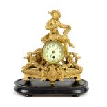 Early 20th century gilt metal single train mantel clock with figural finial, 37cm..