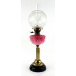 Late Victorian brass oil lamp with pink moulded glass reservoir 43cm high inc burner.
