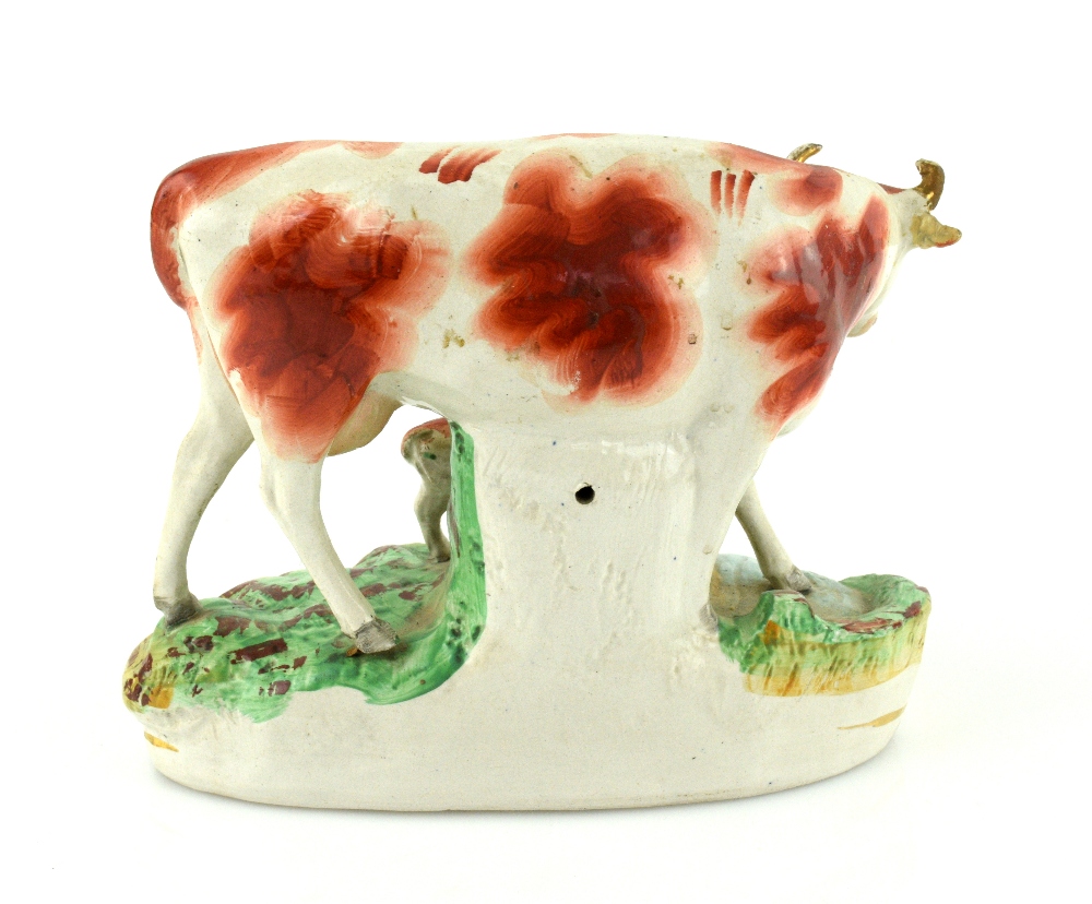 A pair of 19th century Staffordshire models of cows and calves, each 23 cm wide. - Image 4 of 8
