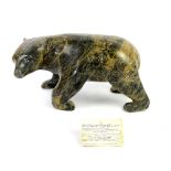 Inuit carved stone polar bear by Pavinaq Petaulassie, Cape Dorset, 14cm high, with certificate..