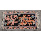 Pair Chinese rugs designed with dragons and flaming pearls, 164cm x 89cm. Part worn in places loss