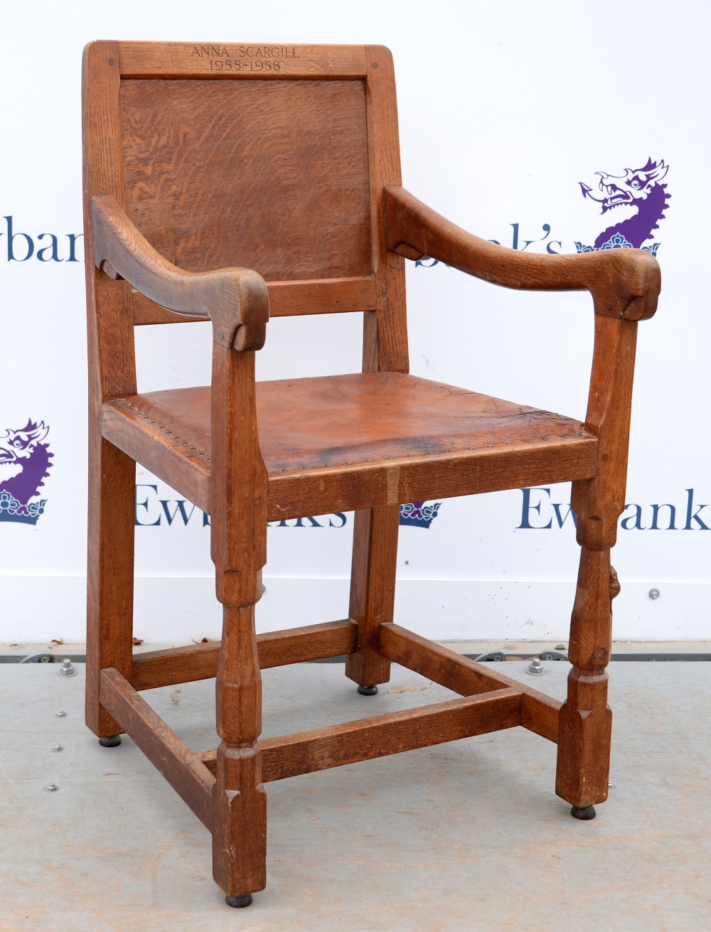 Robert 'Mouseman' Thompson of Kilburn, oak armchair with buttoned brown leather seat, raised on