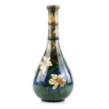 A Tall vase in the manner of Della Robbia Birkenhead, with ringed neck and painting of narcissi