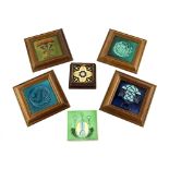 A group of Arts & Crafts tiles, four framed tiles with tubelined or moulded decoration, a framed