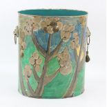 A painted waste paper bin, with lion mask handles, possibly by Mary Wondrausch, 32 cm .