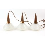 1970s teak and glass three lamp pendant light fitting and a coppered metal and frosted glass