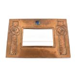 Scottish Arts & Crafts, a copper framed mirror with central enamel plaque and Glasgow rose