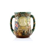 Doulton a George V and Mary Jubilee loving cup with decoration of monarchs in relief, the reverse