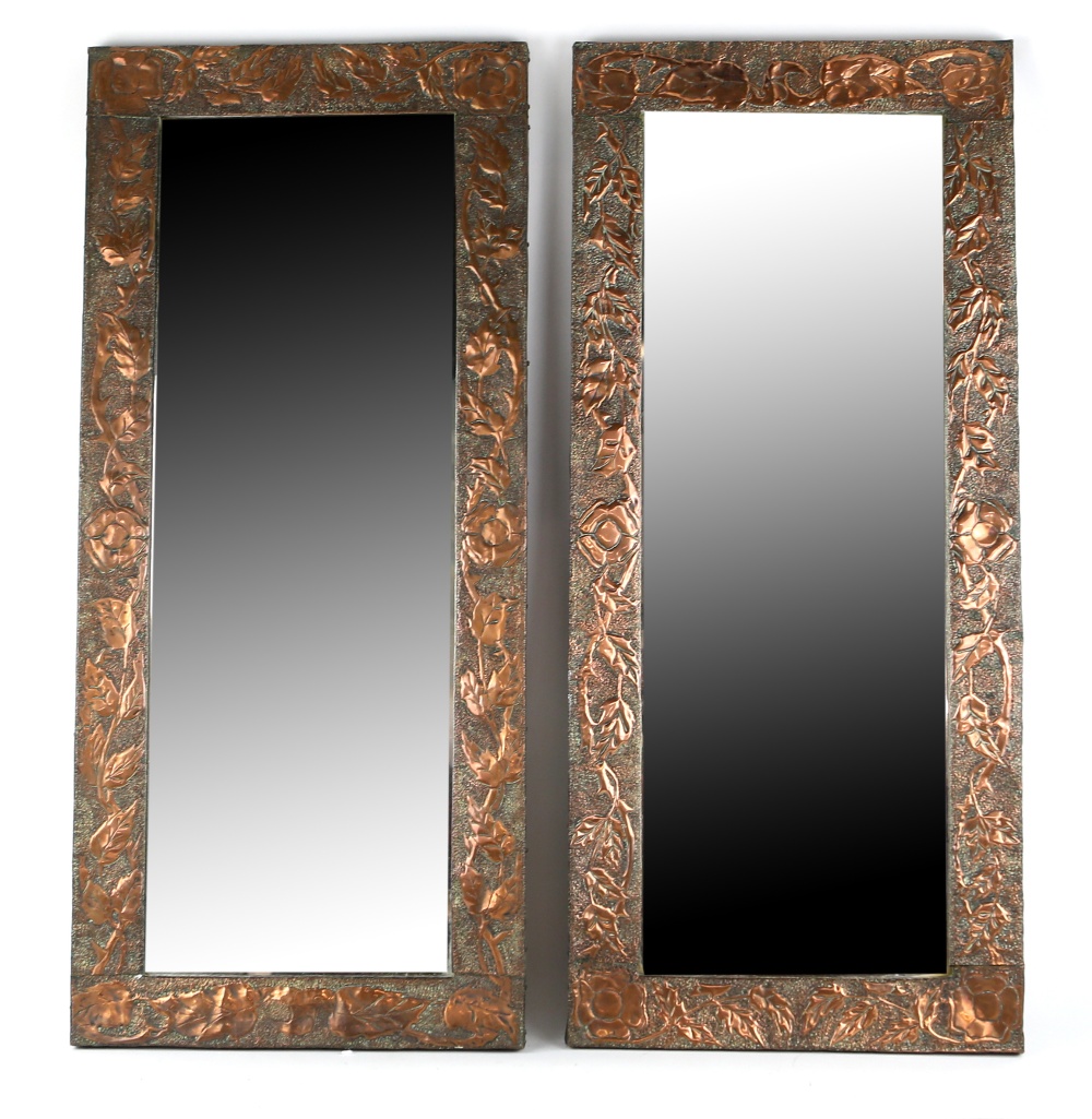 A Pair of copper framed mirrors, with hammered design of leaves, 85.5cm x 38cm.