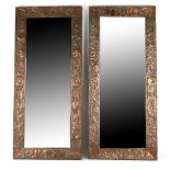 A Pair of copper framed mirrors, with hammered design of leaves, 85.5cm x 38cm.