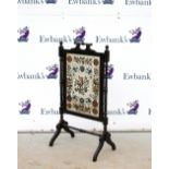 Aesthetic movement ebonised fire screen, with painted glass panel depicting a robin on a branch