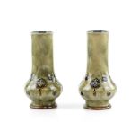 Doulton a pair of stoneware vases with Art Nouveau style decoration and Glasgow Rose raised