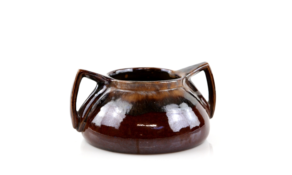 An early 20th C Art Pottery twin-handled vase in a brown and lustre glaze, unmarked, 9cm high,.