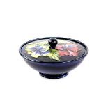 Moorcroft Hibiscus pattern bowl and cover on a blue ground, impressed factory marks to base and