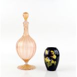 A mid 20th C Venetian glass decanter, the fluted ovoid shape in pink glass speckled with gold, 34