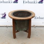 Studded copper tub in oak stand, 50cm high..