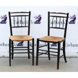 A pair of ebonised rush seated chairs in the manner of William Morris Sussex chairs .