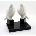 K B Sturgess, pair of white marble doves, signed on foot, on polished slate marble base, 31cm.
