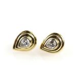 A pair of contemporary diamond earrings, set with pear cut diamonds, estimated total diamond