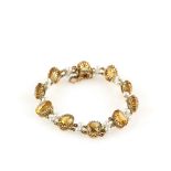 Citrine and cultured pearl bracelet; ten oval cut citrines alternated with two cultures pearls, with