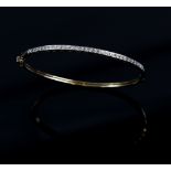 Modern diamond set oval hinged bangle, set with Swiss cut diamonds, estimated total diamond weight