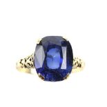 C 1900 a gold ring set with large cushion cut synthetic sapphire, the openwork mount with gothic