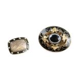 A Victorian brooch set with banded agate, gold leaf scrolls and enamel, the reverse with locket