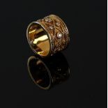 Gold Etruscan style ring set with diamonds and beaded decoration within a rope twist border,