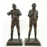 Lindel, pair of terracotta figures of men, on square bases, 34cm . Please see ewbanks.co.uk for