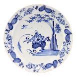 18th century Delft charger, with floral and foliate decoration in underglazed blue, 34cm